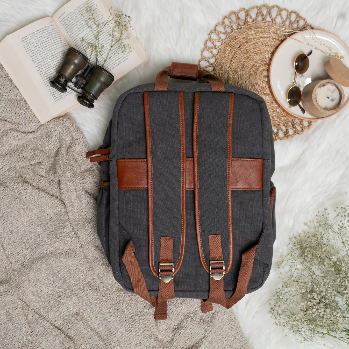 Life in grey traveller's backpack